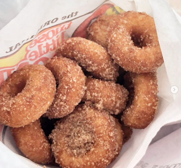 Fresh mini donuts in a Those Little Donuts bag